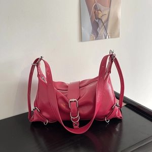 Fuchsia pink punk style shoulder bag with silver buckles and pleated texture