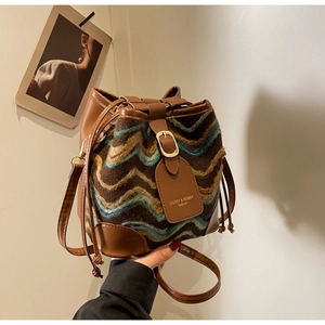 Detailed close-up of retro bucket bag featuring knit jacquard patterns and leather drawstring
