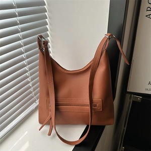 Minimalist caramel brown tote bag with lychee texture and adjustable shoulder strap