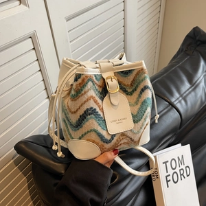 Fashionable bucket bag featuring colorful wave knit patterns and white leather straps