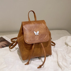 Vintage brown PU leather backpack with silver butterfly detail and drawstring closure