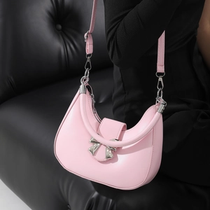 Pink crescent shoulder bag with silver bow detail and versatile straps for women