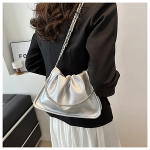 Close-up of silver pleated cloud bag featuring fine metallic texture and chain strap