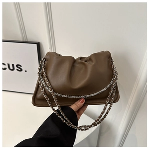 Detail view of dark coffee pleated crossbody bag with silver chain straps and matte finish