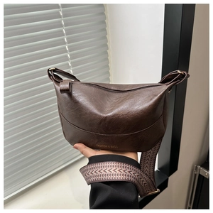 Detail of dark brown faux leather crossbody bag with ethnic jacquard wide strap