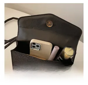 Interior view of black sequin evening bag showing space for phone and makeup
