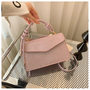 Close-up of lilac sequin handbag featuring a woven rope handle and gold ring buckle