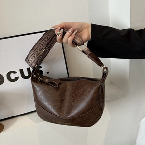 Vintage dark brown PU leather hobo bag with retro texture and wide woven shoulder strap