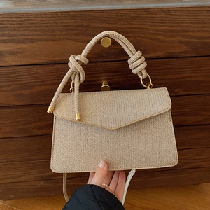 Sparkly rose gold crossbody handbag with elegant top handle and metallic shimmer finish