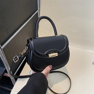 Fashionable black PU leather saddle bag with gold metal hardware and top handle