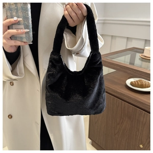 Close-up of black fluffy faux fur hobo bag with subtle shimmer and zip closure details