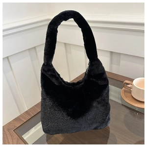 Close-up of black faux fur hobo bag with plush texture and metallic zipper detail