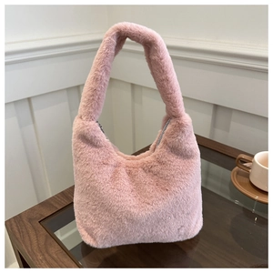 Detailed close-up of pink faux fur texture and silver metal zipper on a plush handbag