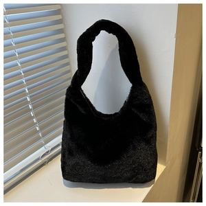 Detailed close-up of fluffy black hobo bag texture with soft natural shadow on window sill