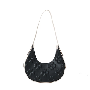 Elegant black hobo shoulder bag with embossed clover pattern and white leather strap