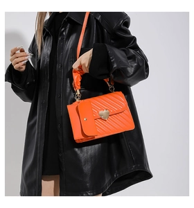 Fashionable bright orange pleated crossbody bag with heart buckle and mini pouch detail