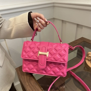 Chic magenta quilted handbag with golden buckle and crossbody strap for women