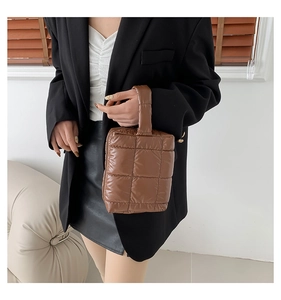 Brown quilted puffer handbag in glossy nylon with soft grid texture and top handle