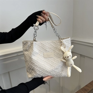Creamy white quilted tote bag with chain strap and cute bunny pendant charm