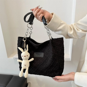Large black textured tote bag with silver chain and cute white rabbit pendant