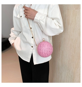 Detail view of pink spherical evening clutch with sparkling sequins and gold chain strap