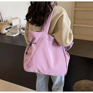 Detail view of large lavender tote bag with adjustable side drawstring and matte texture