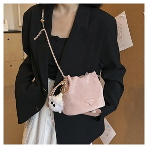 Pink drawstring bucket bag detail with textured finish and monster plush keychain