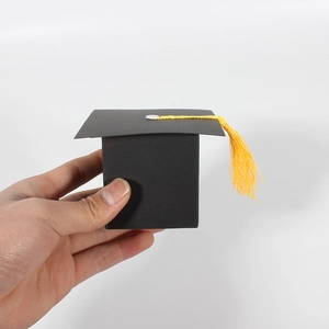 Detail of graduation cap candy box with black matte finish and yellow tassel decoration