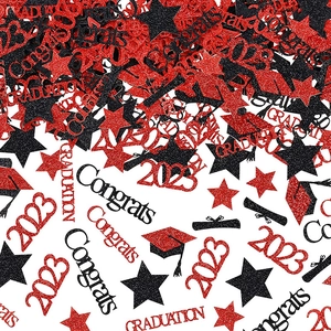 Close-up of red and black glitter graduation confetti with cap and diploma shapes