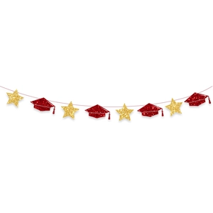 Detail of red glitter graduation caps and gold stars on festive party banner garland