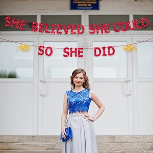 Red glitter She Believed She Could So She Did banner for graduation party decor