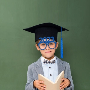 Close-up of a student wearing 2023 glitter blue paper glasses for graduation party