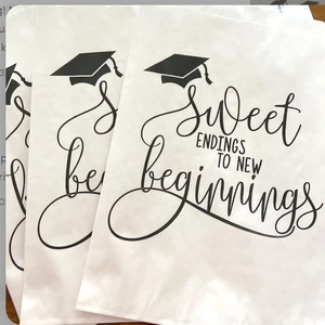 Close-up of graduation candy bags with Sweet Endings To New Beginnings text print