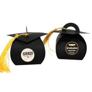 Detail of black graduation cap gift boxes with yellow tassels and Congrats Grad labels