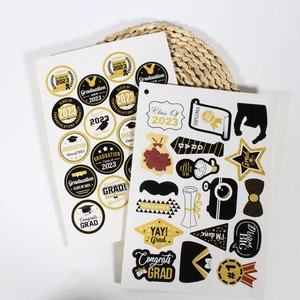 2023 graduation sticker set featuring black and gold caps, scrolls and congrats grad slogans