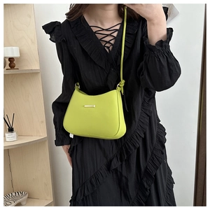 Lime green hobo shoulder bag with sleek gold bar metal detail and slim strap