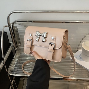 Elegant beige bow-knot crossbody bag with silver metal decor and leather strap