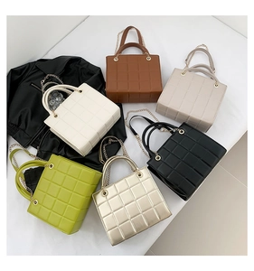 Flat lay of retro quilted crossbody bags in six colors with gold chain straps