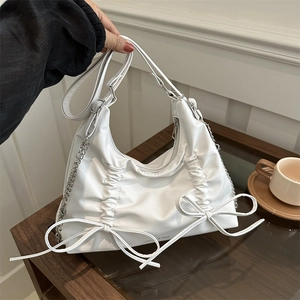 White soft leather shoulder bag with bow details and stylish silver chain strap