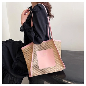 Detail of pink faux leather pocket and woven texture on a large fashion tote bag