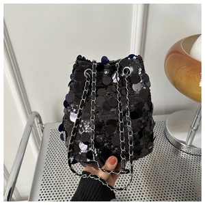 Close-up of black sequins and silver chain strap on this stylish bucket shoulder bag