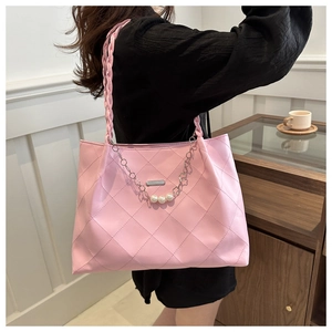 Pink quilted tote bag with pearl flower chain detail and woven shoulder strap