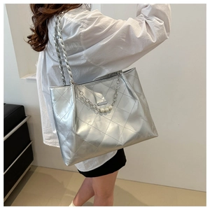 Detail of silver metallic tote bag with quilted pattern and pearl chain strap