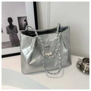 Detail of silver quilted tote bag with metallic leather and elegant pearl chain strap