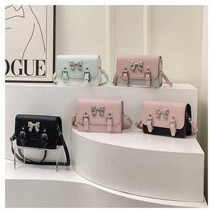 Collection of chic crossbody bags with metal bow accents in various pastel colors