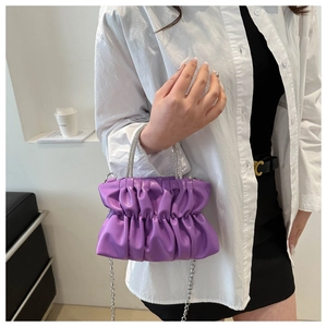 Detail of lavender ruched cloud bag with sparkling rhinestone handle and silver chain strap