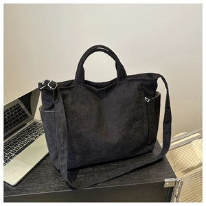Détail du sac fourre-tout en velours côtelé noir montrant la texture et la bandoulière