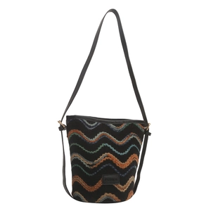 Knitted bucket bag with colorful wavy patterns and black leather strap shown from the front