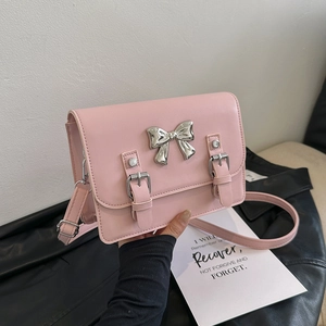 Pink bow square crossbody bag with silver butterfly accent and dual decorative straps