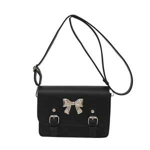 Minimalist black PU leather crossbody bag featuring a silver bow and metal buckles
